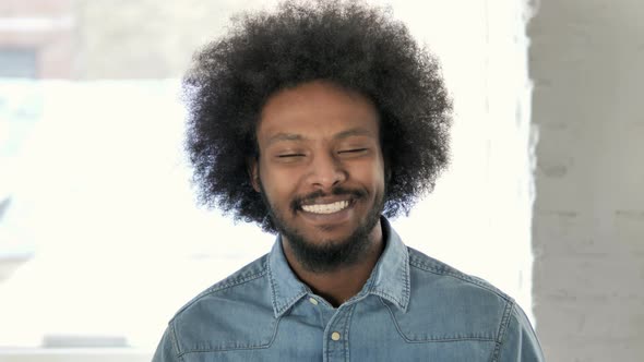 Smiling Young African Man Looking at Camera