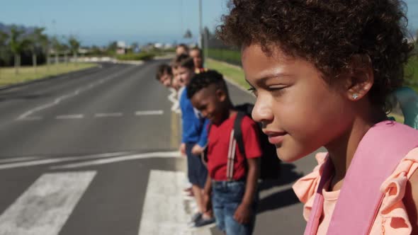 Group of kids looking for traffic before crossing the road