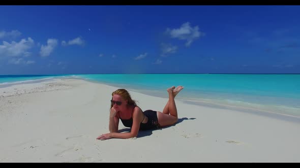 Ladies happy and smiling on perfect island beach holiday by blue water with bright sand background o