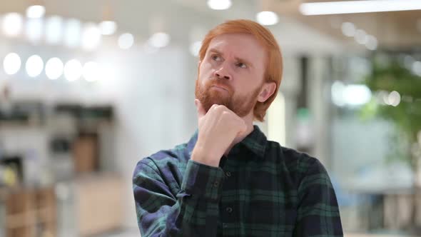 Portrait of Curious Beard Redhead Man Thinking About Something