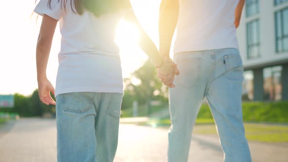 Dad and Daughter Walk Around Their Area at Sunset