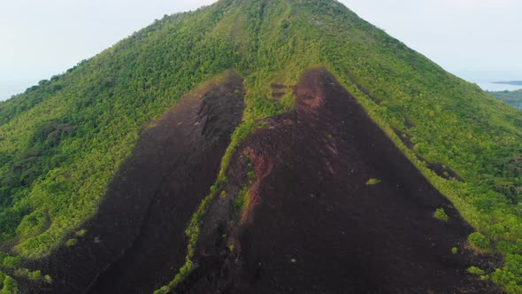 Aerial: flying over Banda Islands active volcano Gunung Api lava flows Indonesia