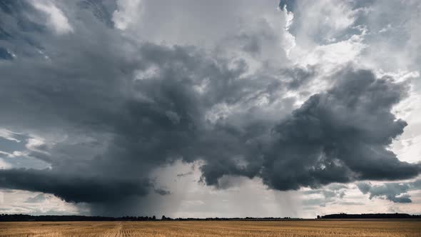 Dark stormy cloud going forward in the fields. Time lapse video.