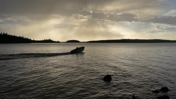 Motorboat sailing on lake on a cloudy day