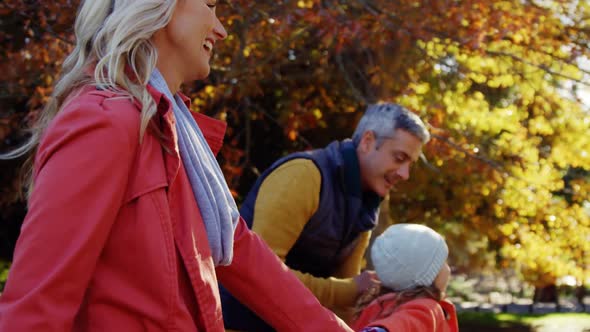 parents and daughter running outdoors