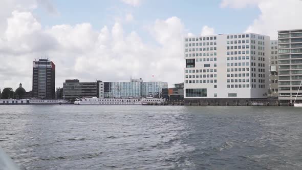 Canal Cruise Boat Ride on River through Amsterdam, Netherlands - POV