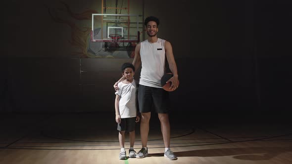 Portrait of Happy Basketball Player and His Son