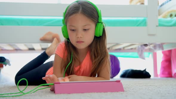 Girl using digital tablet on floor at home 4k