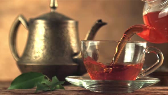 Super Slow Motion in a Glass Cup Pour Black Tea