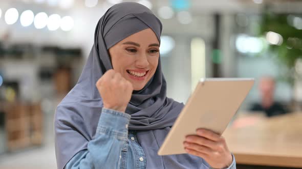 Arab Woman Celebrating Success on Tablet, Winning 