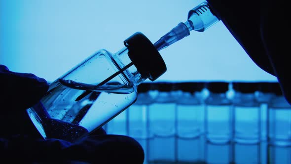 Vaccine bottles and syringe injection. Glass vials for liquid samples in laboratory.