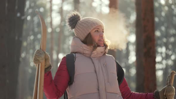 Young Woman Skier Enjoying Nature in Winter Frosty Sunny Weather