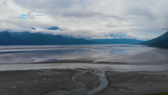 4K Cinematic Drone Video (slow dolly back) of Mountains Overlooking Turnagain Arm Bay at Low Tide Ne