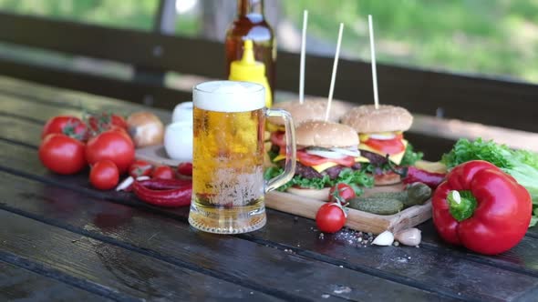 Cheeseburgers Served with French Fries on a Board Outdoors