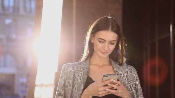 Beautiful Business Woman Using Mobile Phone Outdoor On Sunny Day