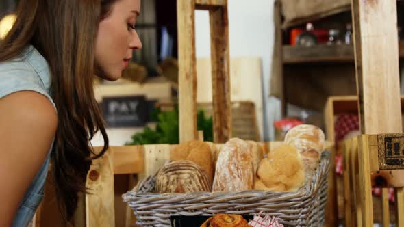 Woman purchasing bread at bakery section