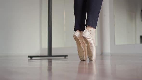 Closeup of Legs in Pointe Shoes That Rise on Toes