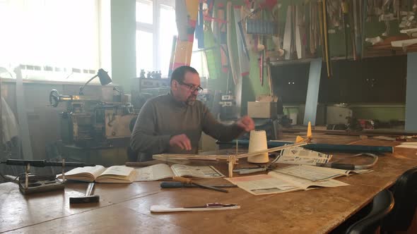 Man Working in a Locksmith Shop