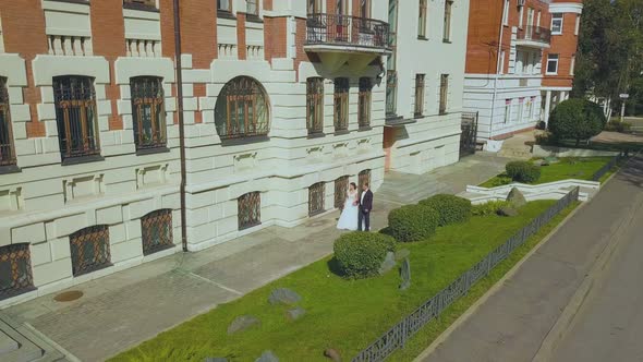 Just Married Couple Walks Past Restored Building Upper View