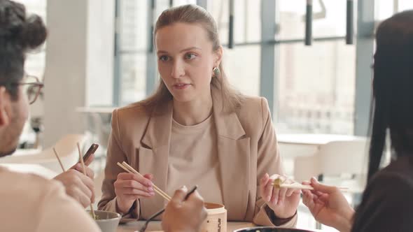 Woman Having Lunch with Colleagues at Food Court