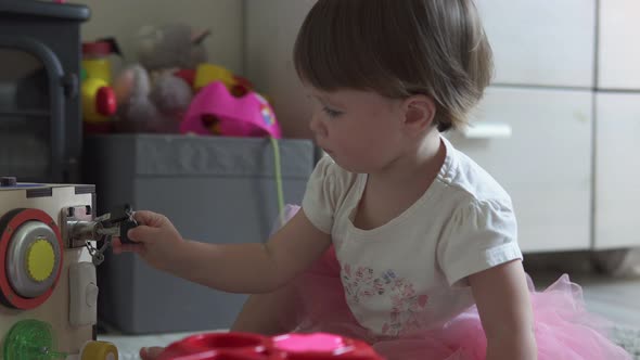 Cute Baby Girl Playing with Toy at Home