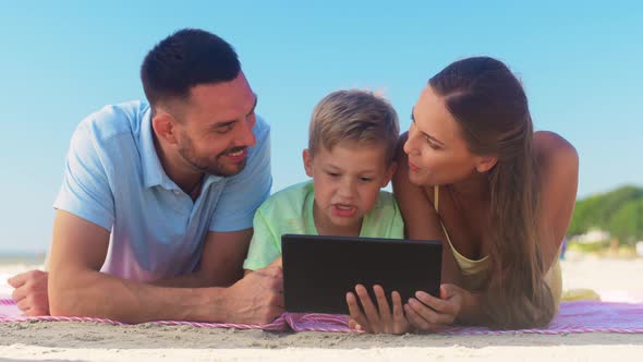 Happy Family with Tablet Computer on Summer Beach