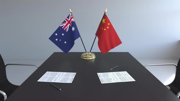 Flags of Australia and China on the Table