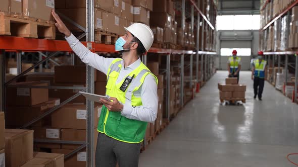 Inventory Manager Doing Stocktaking in Storehouse