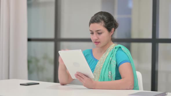 Indian Woman Using Tablet While Sitting in Office