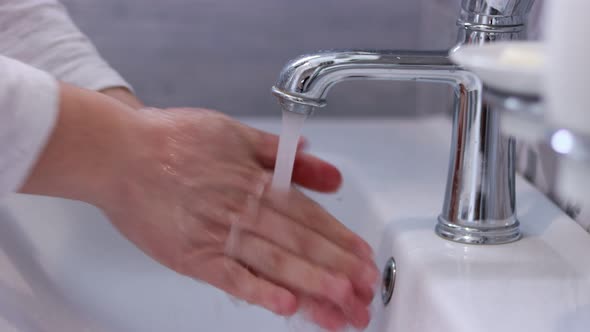 Man washing hands in the bathroom