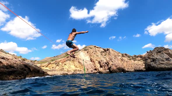 Sportsman Slacklining over mediterranean sea.