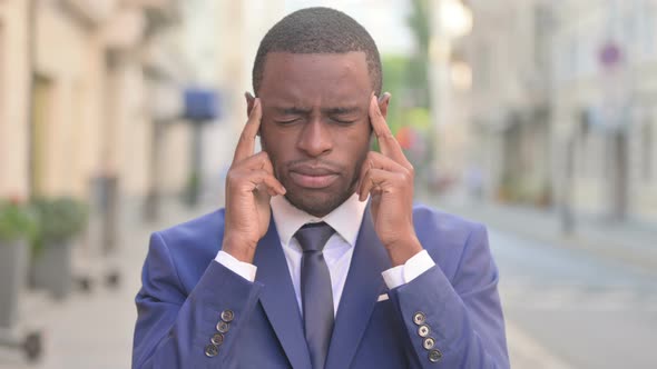 Outdoor African Businessman Having Headache