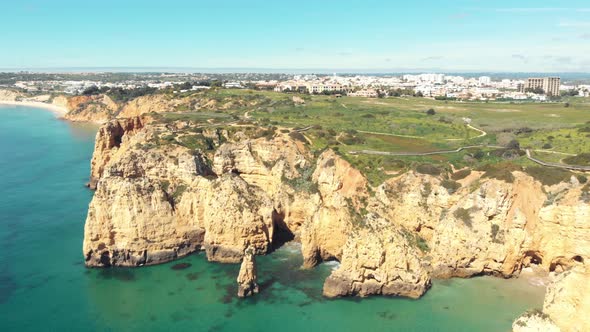 Aerial forward over Atlantic sea approaching cliffs, Lagos, Algarve, Portugal