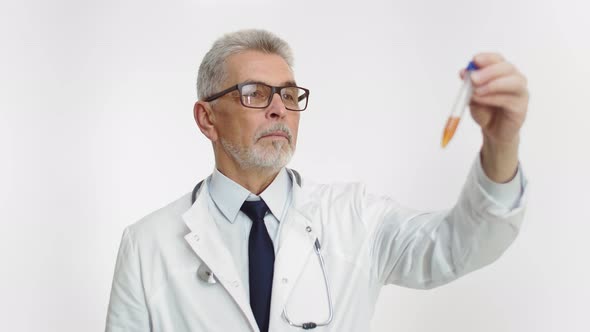 An Adult Doctor Holds a Test Tube with Liquid in His Hand