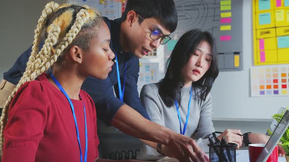 Asian staff creative senior designer coworkers consulting in office on how to solve a problem