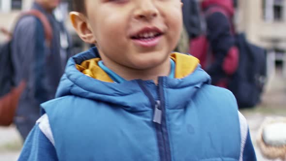 Smiling Refugee Boy with Plush Bear