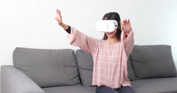 Woman watching with VR device at home