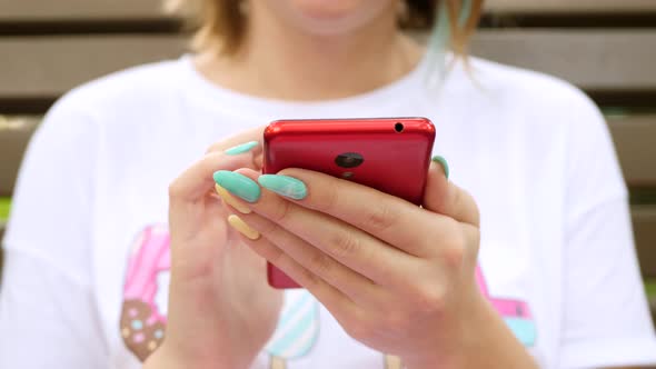 Woman Use Smartphone Sits on Bench in Summer Park