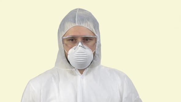 Portrait of a Man Wearing Antiviral Respiratory Mask Looking Aroung in Panic
