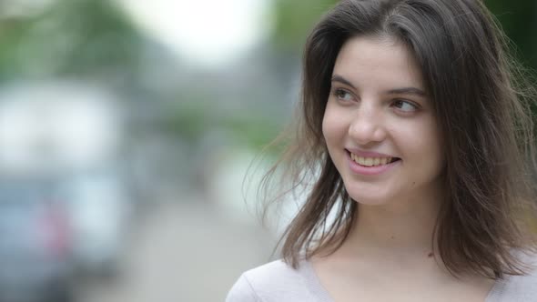 Young Happy Beautiful Woman Thinking in the Streets Outdoors