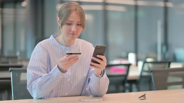 Young Woman Making Successful Online Payment on Smartphone