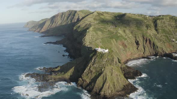 Aerial View of lighthouse on the peak of the cliff by the ocean, Santo Espirito.