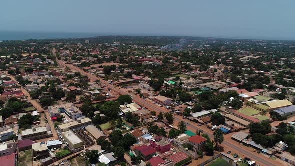 Aerial flight towards an unnamed road in Serrekunda above the Manjai football field