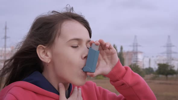 The girl is choking with asthma.