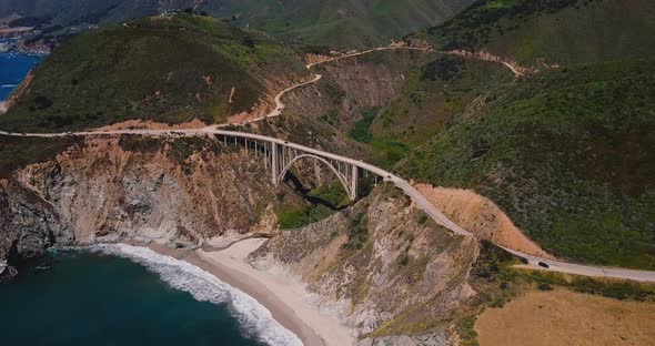 Beautiful Cinematic Aerial Shot of Epic Famous Bixby Canyon Bridge and Highway 1 Summer Scenery in