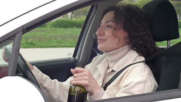 Woman is Drinking Wine While Sitting in Her Car