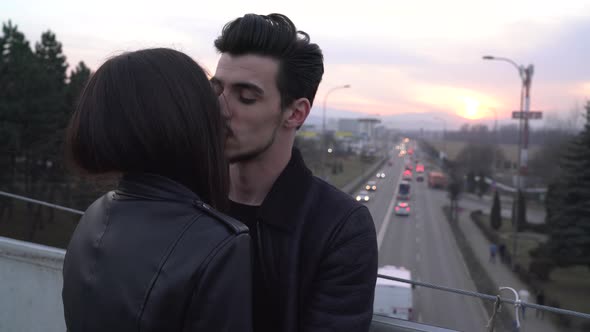 Couple standing on a bridge  alt