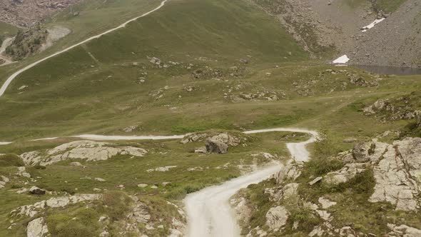 Cinematic Aerial View Gravel Trail Road on the Mountain