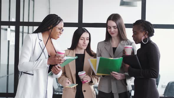 Multiethnic Business Colleagues Reviewing Paper Documents