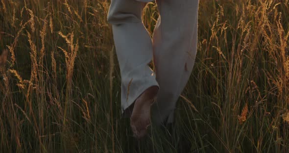 A Young Guy Walks Through a Wheat Field